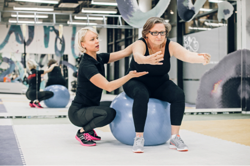 Personal trainer working with senior woman
